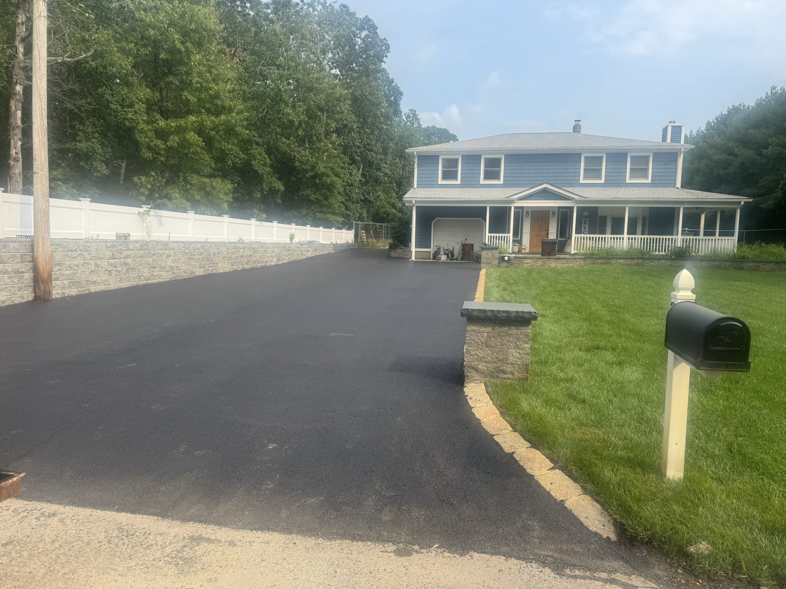 Finished asphalt driveway with a block border in Ocean County, New Jersey